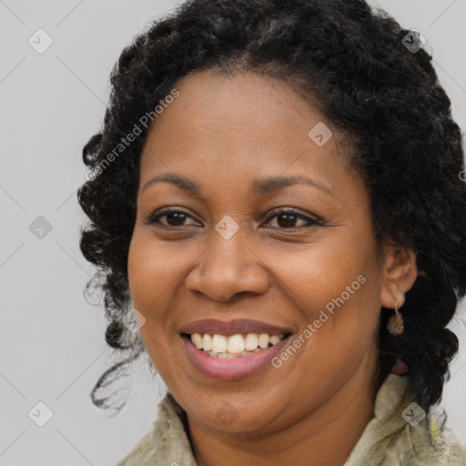 Joyful black adult female with long  brown hair and brown eyes