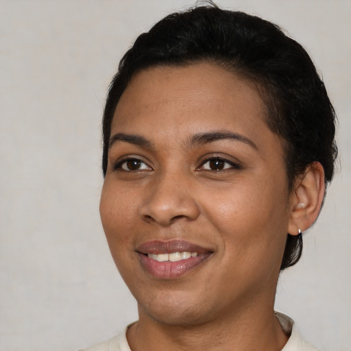 Joyful latino young-adult female with short  black hair and brown eyes