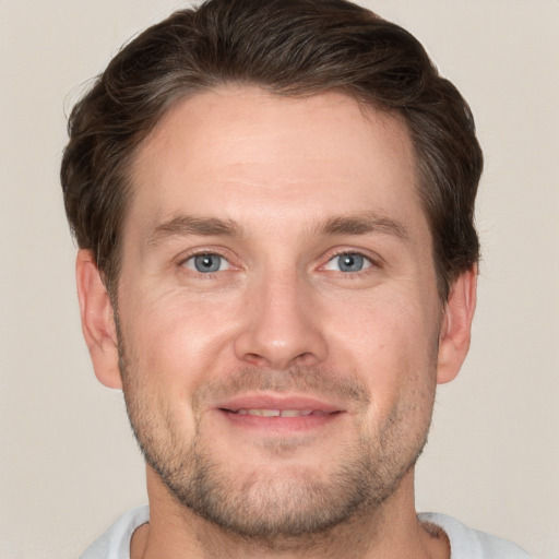 Joyful white adult male with short  brown hair and grey eyes