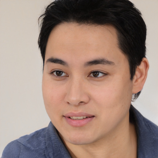 Joyful asian young-adult male with medium  black hair and brown eyes
