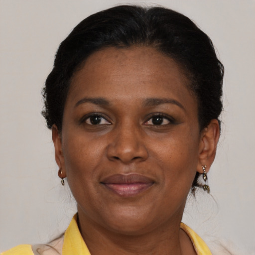 Joyful black adult female with short  brown hair and brown eyes