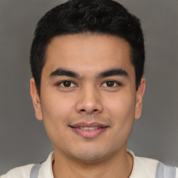 Joyful latino young-adult male with short  black hair and brown eyes