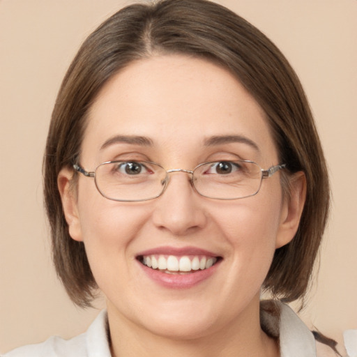 Joyful white adult female with medium  brown hair and green eyes