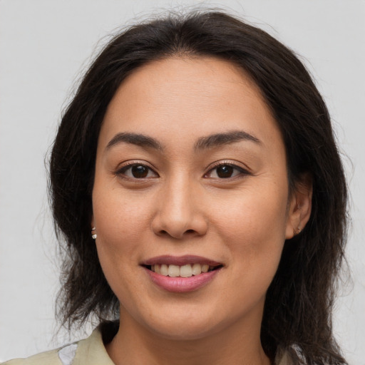 Joyful asian young-adult female with long  brown hair and brown eyes