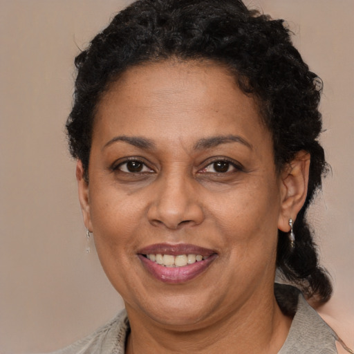 Joyful black adult female with short  brown hair and brown eyes