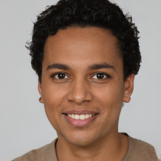 Joyful black young-adult male with short  brown hair and brown eyes