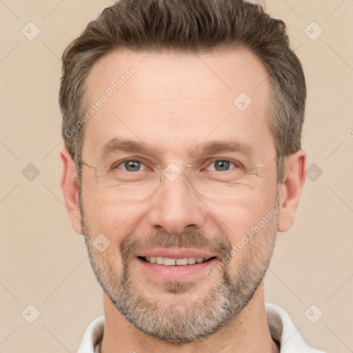 Joyful white adult male with short  brown hair and grey eyes