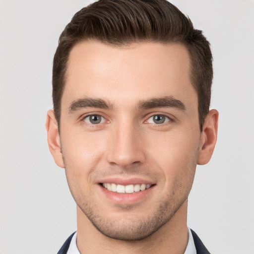 Joyful white young-adult male with short  brown hair and brown eyes