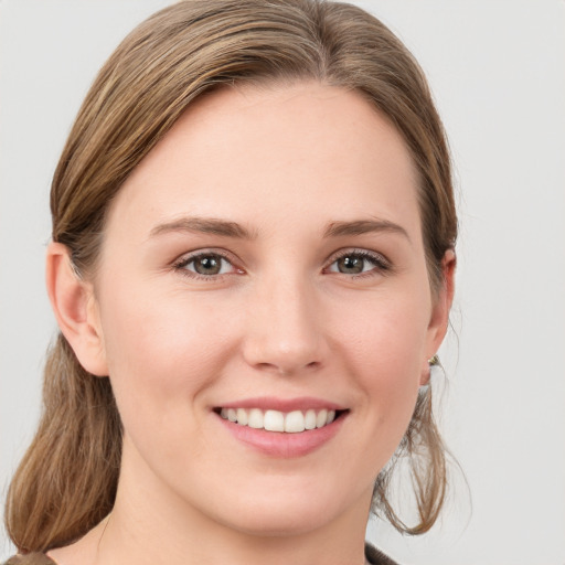 Joyful white young-adult female with medium  brown hair and blue eyes