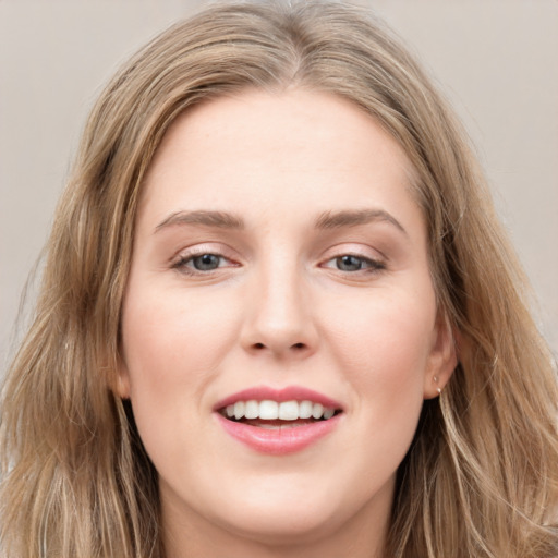 Joyful white young-adult female with long  brown hair and grey eyes