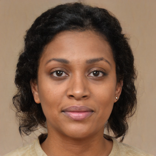 Joyful black young-adult female with medium  brown hair and brown eyes