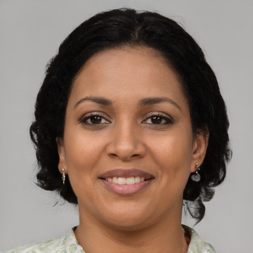 Joyful latino young-adult female with medium  black hair and brown eyes