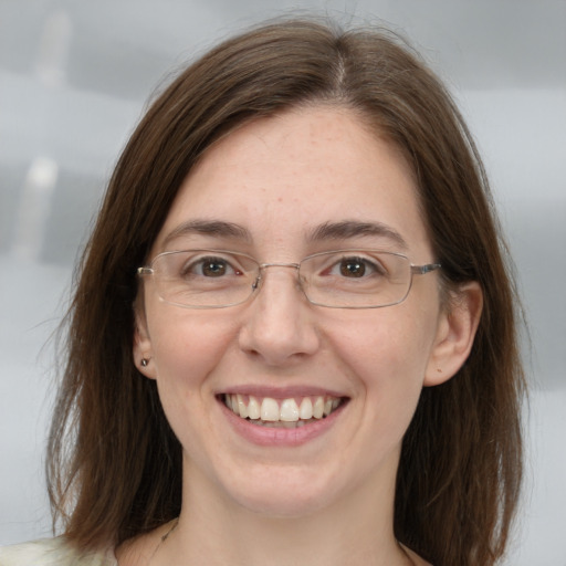 Joyful white adult female with medium  brown hair and grey eyes