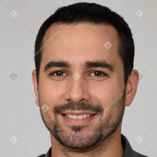 Joyful white young-adult male with short  black hair and brown eyes