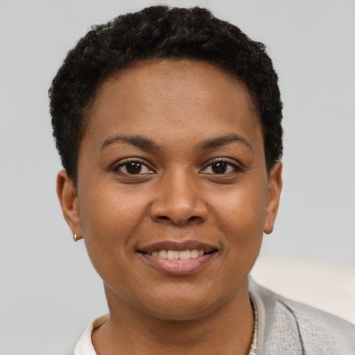 Joyful black young-adult female with short  brown hair and brown eyes