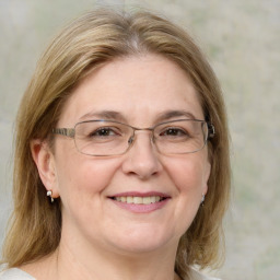 Joyful white middle-aged female with medium  brown hair and blue eyes