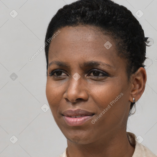 Joyful black young-adult female with short  black hair and brown eyes