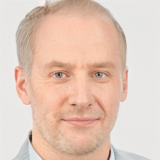 Joyful white adult male with short  brown hair and grey eyes