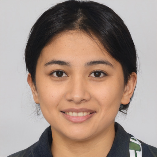 Joyful asian young-adult female with medium  brown hair and brown eyes