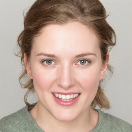 Joyful white young-adult female with medium  brown hair and blue eyes