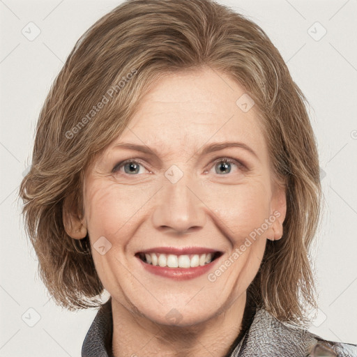 Joyful white adult female with medium  brown hair and blue eyes