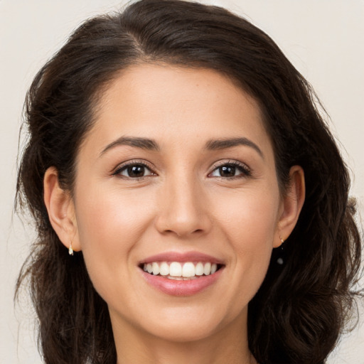 Joyful white young-adult female with long  brown hair and brown eyes