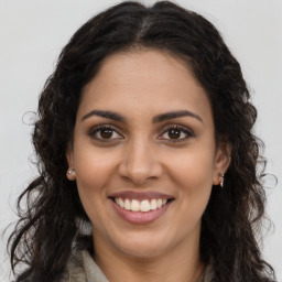 Joyful latino young-adult female with long  brown hair and brown eyes