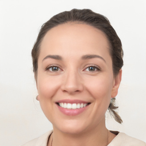 Joyful white young-adult female with medium  brown hair and brown eyes