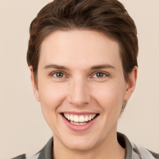 Joyful white young-adult female with short  brown hair and grey eyes