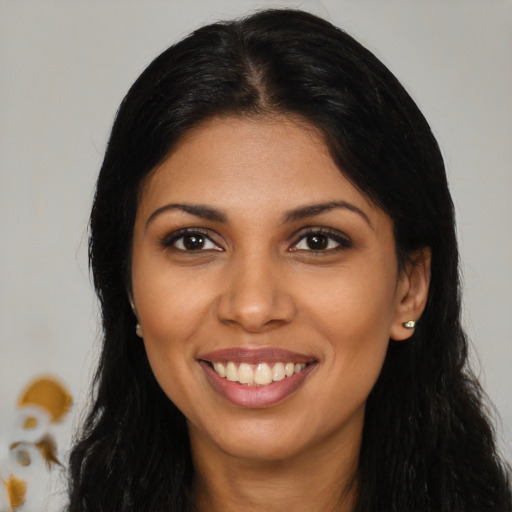 Joyful latino young-adult female with long  black hair and brown eyes