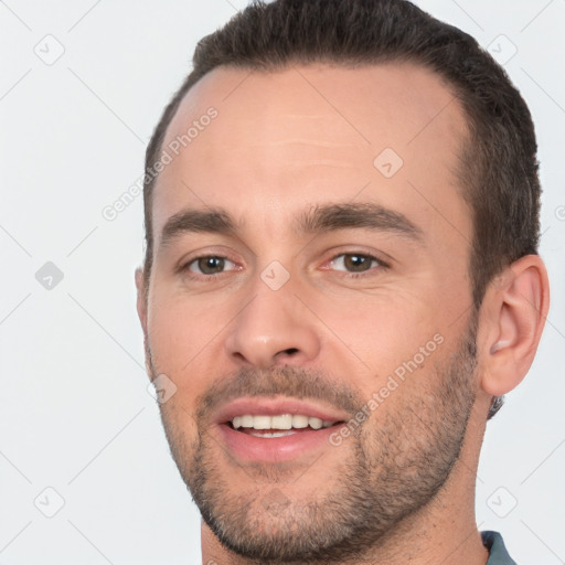 Joyful white young-adult male with short  brown hair and brown eyes