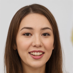 Joyful white young-adult female with long  brown hair and brown eyes