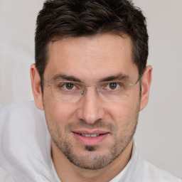 Joyful white adult male with short  brown hair and brown eyes