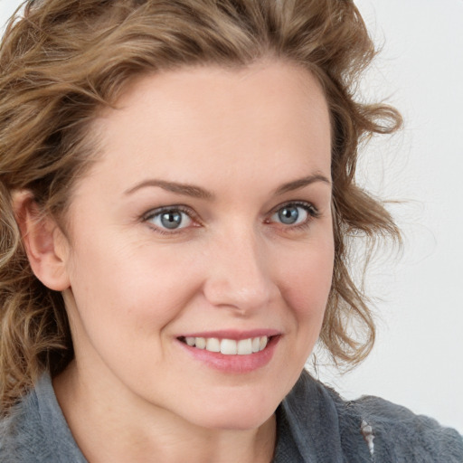 Joyful white young-adult female with medium  brown hair and blue eyes