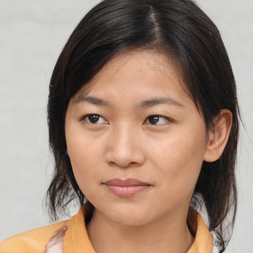 Joyful asian young-adult female with medium  brown hair and brown eyes
