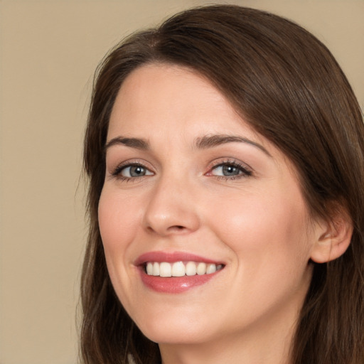 Joyful white young-adult female with long  brown hair and brown eyes