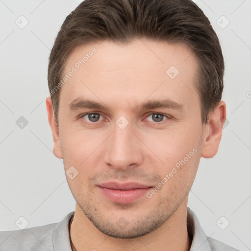 Joyful white young-adult male with short  brown hair and brown eyes