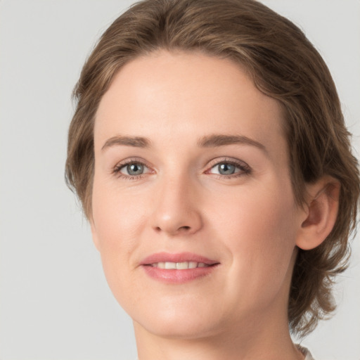 Joyful white young-adult female with medium  brown hair and green eyes