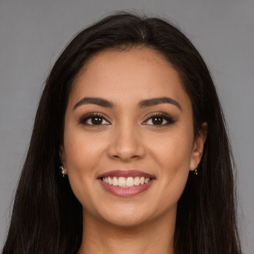 Joyful white young-adult female with long  brown hair and brown eyes