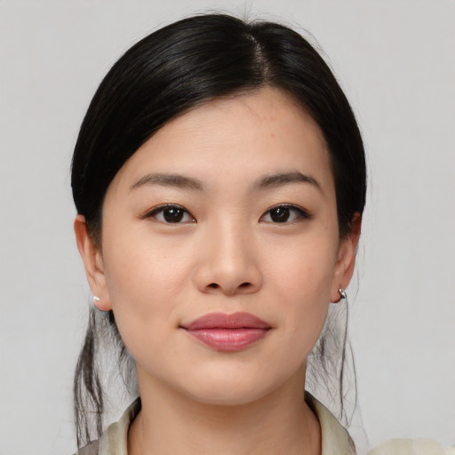 Joyful asian young-adult female with medium  black hair and brown eyes