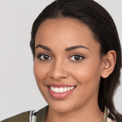 Joyful latino young-adult female with long  black hair and brown eyes