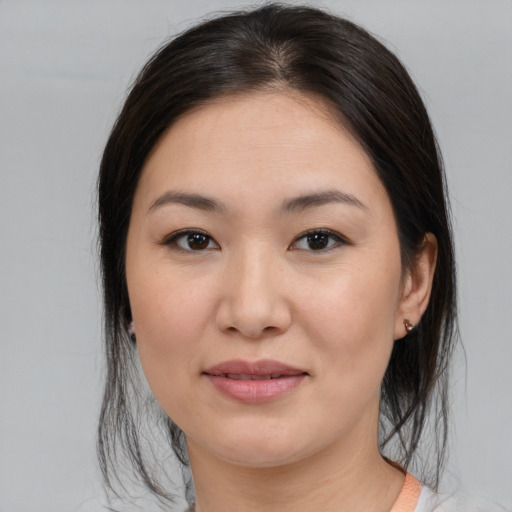 Joyful asian young-adult female with medium  brown hair and brown eyes