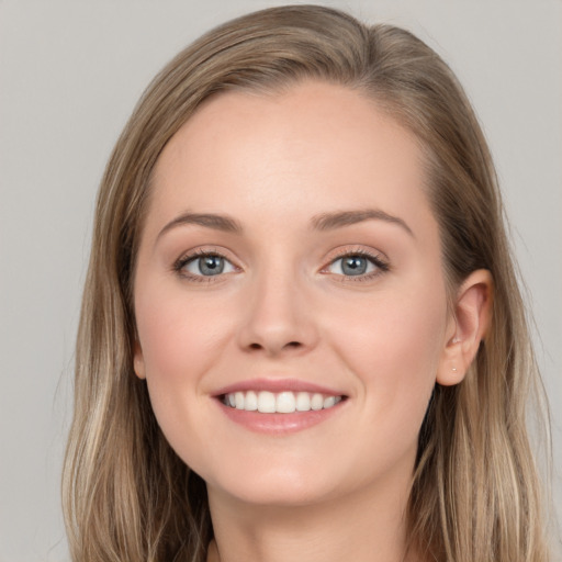 Joyful white young-adult female with long  brown hair and grey eyes