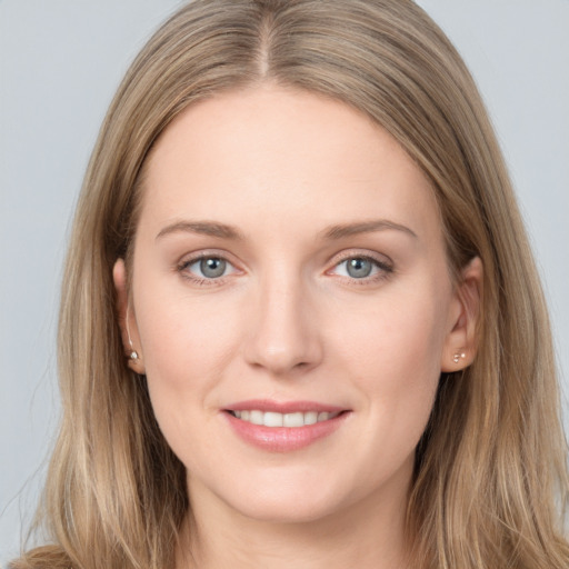 Joyful white young-adult female with long  brown hair and grey eyes