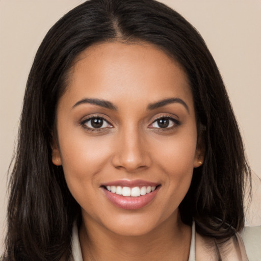 Joyful white young-adult female with long  brown hair and brown eyes