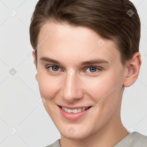 Joyful white young-adult female with short  brown hair and grey eyes