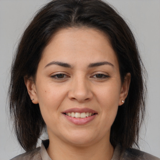 Joyful white young-adult female with medium  brown hair and brown eyes