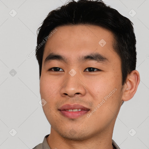 Joyful asian young-adult male with short  black hair and brown eyes