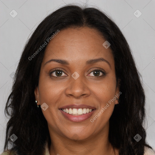 Joyful black young-adult female with long  brown hair and brown eyes