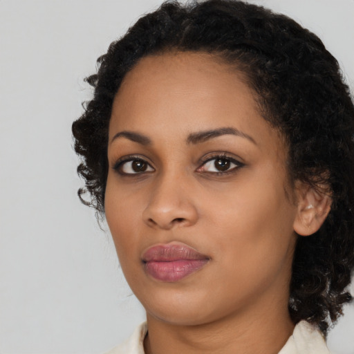 Joyful black young-adult female with medium  black hair and brown eyes